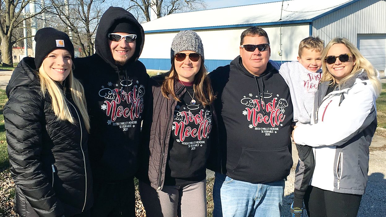 Members of Ayden O’Malley’s family were on hand for the third annual First Noelle 5K on Saturday, Dec. 5, in Nokomis and handed out thank you bags to all of the participants. From the left, are Kaniesha Hoehn, Nick O’Malley, Roz O’Malley, Den O’Malley and Brody and Amber Wright.