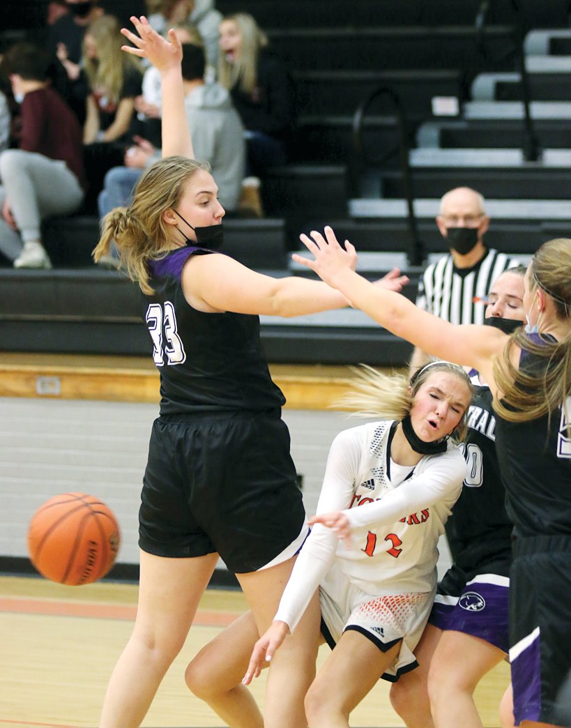 Hillsboro's Layne Rupert gets the pass off before a trio of Breese Central players converge on her during the Toppers' season opener on Monday, Nov. 15, in Hillsboro. Rupert finished with 15 points in the Toppers' 57-40 loss to the Cougars.