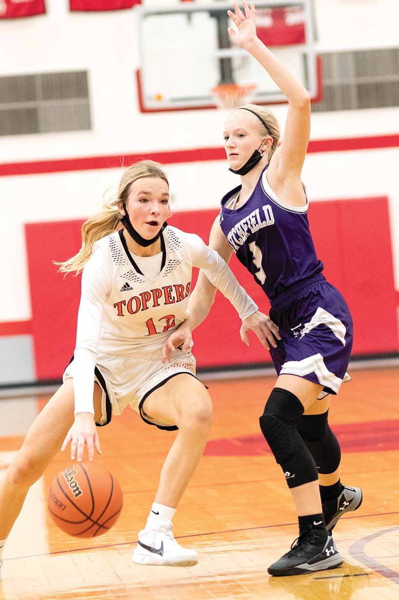 Litchfield's Elise Walch and the rest of the Panthers had their hands full in guarding Hillsboro guard Layne Rupert on Saturday, Dec. 11. Rupert poured in 30 points in the Toppers' 52-26 win over Litchfield, a new girls' record for points scored at the T. Todt Shootout.