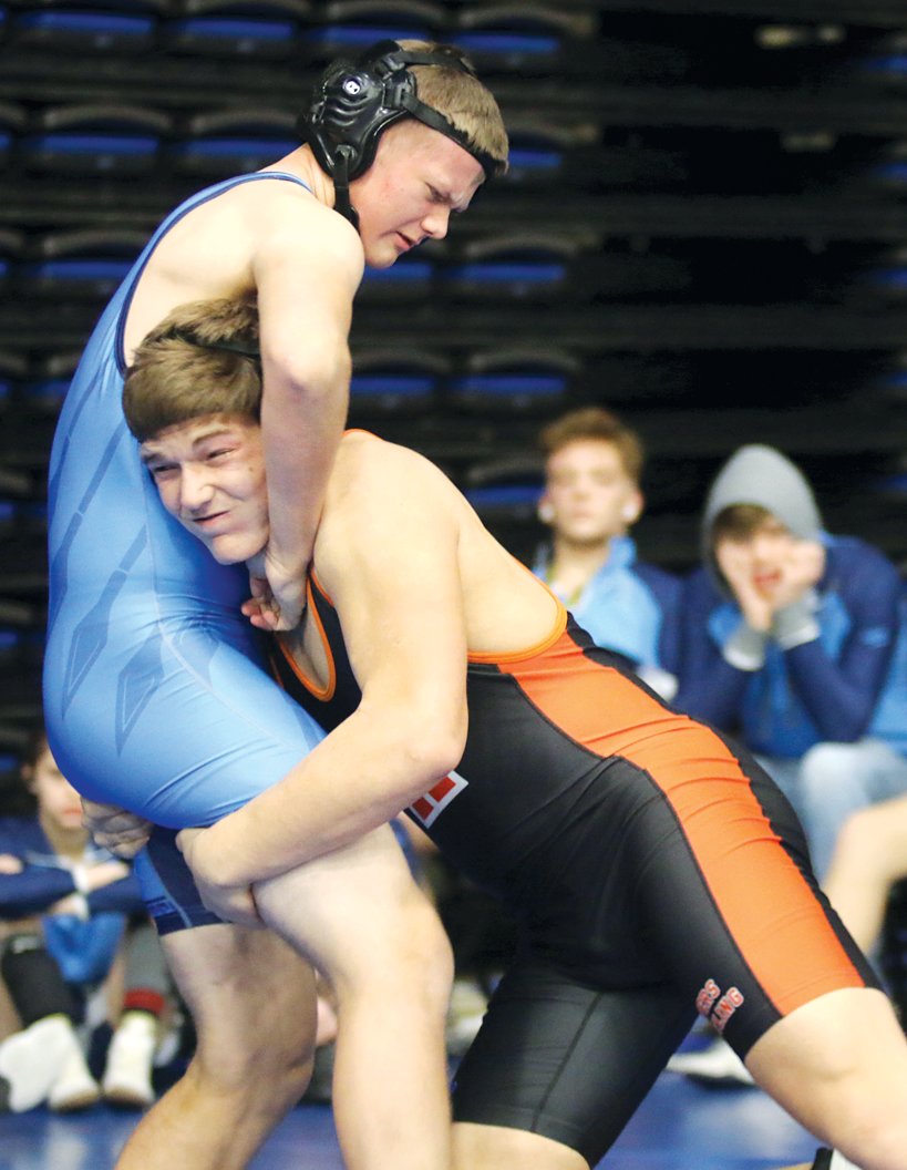 Hillsboro's Magnus Wells drives forward into Olympia's Nolan Yeary during their match at Abe's Rumble on Thursday, Dec. 30. Wells went on to pin Yeary at the 1:47 mark of the match, one of eight wins for the Topper senior at the Springfield tournament.