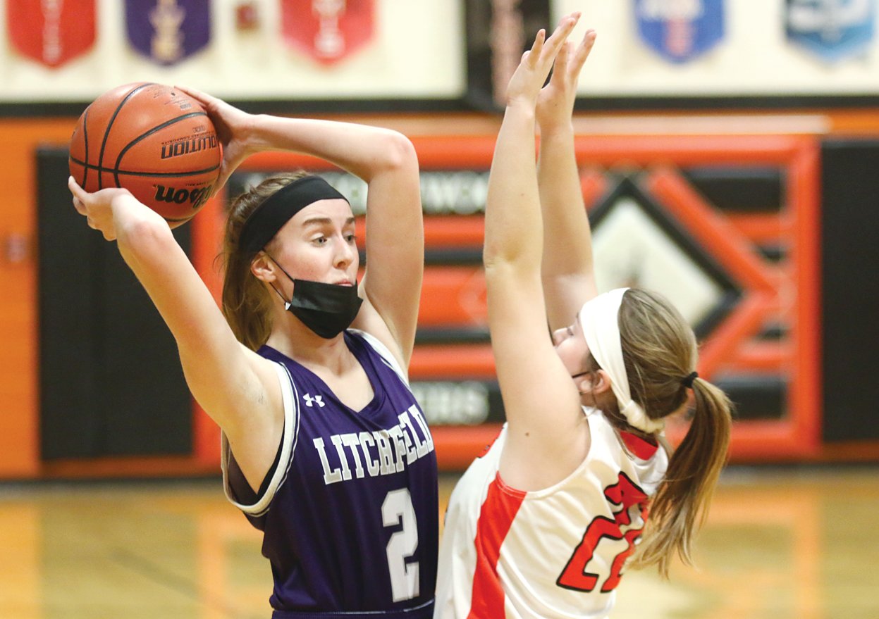 Lincolnwood’s Taryn Millburg closely guards Litchfield’s Carly Guinn (#2) during the county squabble in Raymond on Monday, Jan. 3. Guinn scored seven of her nine points in the first half for the Panthers, who handed Montgomery County’s other LHS a 53-38 loss.