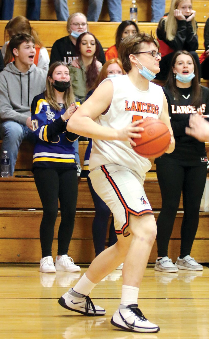 Lincolnwood senior Lucas Reznicek looks for an open teammate in the second half of the Lancers’ 37-29 victory over Roxana on Monday, Jan. 10, in Raymond.